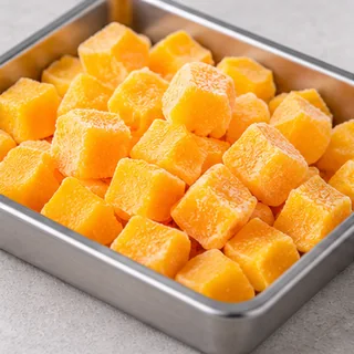 Frozen mango pieces with a light coating of frost