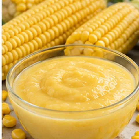 Yellow sweet corn purée beside fresh corn