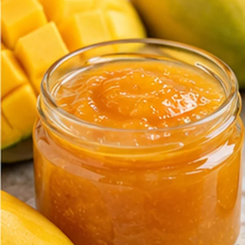 Orange mango jam in a glass jar
