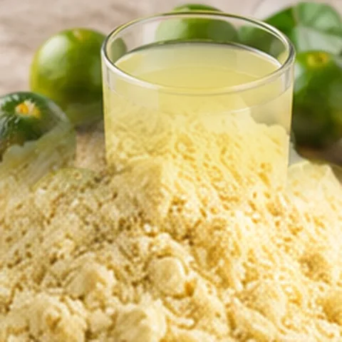 Fine light-colored citrus powder beside calamansi fruit