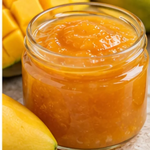 Thick mango fruit preparation in a glass jar